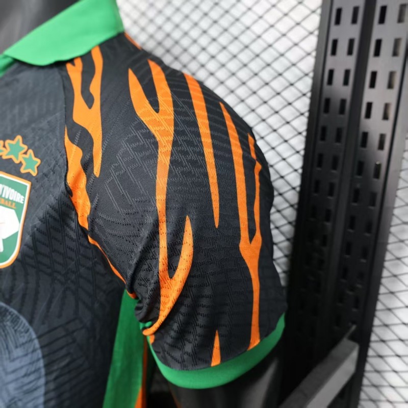 Player Version 2025 Ivory Coast Black with Elephant Graphic and Orange Stripes Jersey